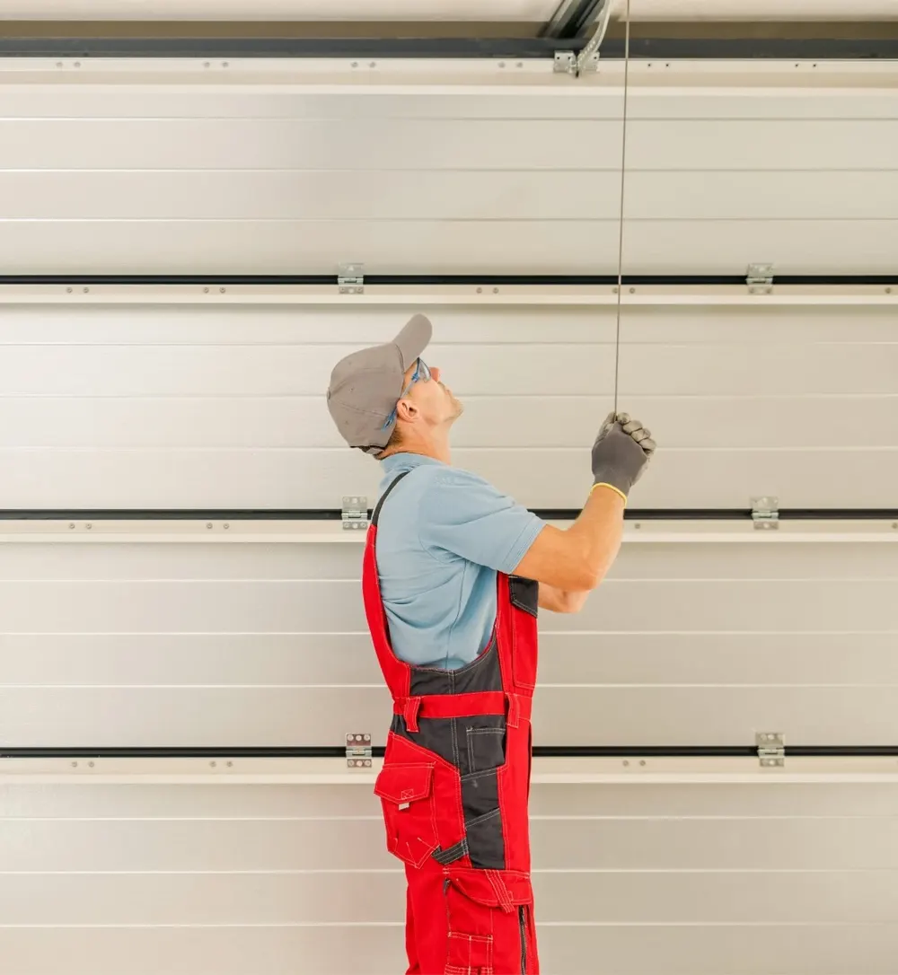 TrueFix technician adjusting a garage door cable in a Calgary garage