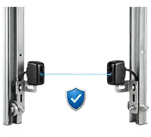 Auto-reverse safety sensor installed at the base of a garage door track